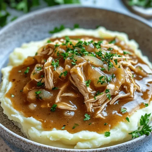 In the world of comfort food, few dishes can compete with the soothing embrace of shredded chicken gravy served over fluffy mashed potatoes. This beloved combination is not just a meal; it’s a nostalgic experience that brings warmth and satisfaction to the table. The tender chicken, enveloped in a rich and flavorful gravy, paired with creamy mashed potatoes creates a symphony of flavors and textures that is hard to resist.